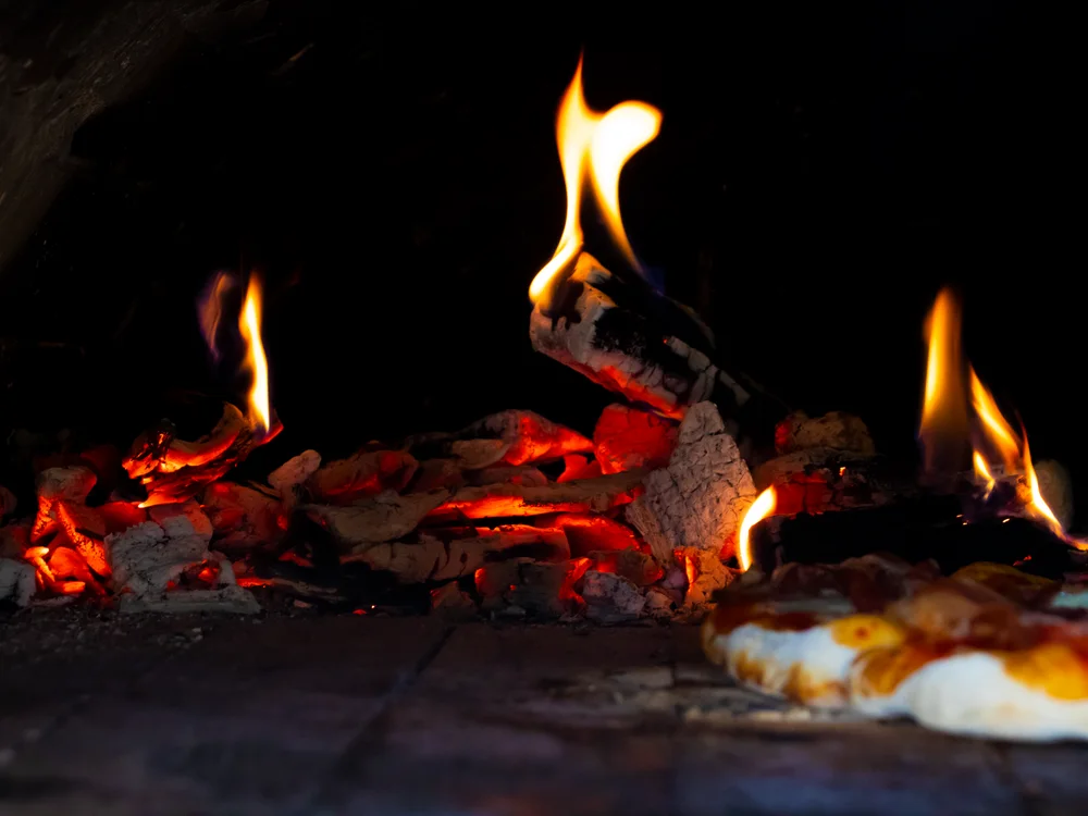 AI-enhanced menu photo of the same pizza — bright and sharp